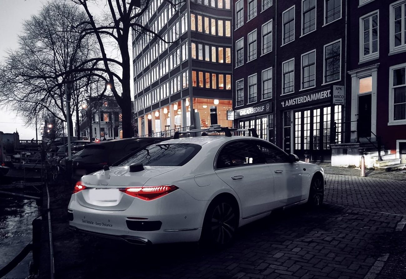 Sensor-equipped saloon on a canal-side street at dusk
