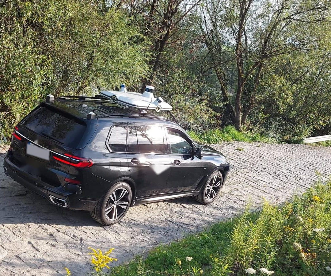 Sensor-equipped SUV on a cobbled riverside ramp